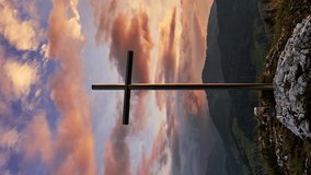  Vertical video Christian cross in mountain nature. .Beautiful colorful clouds at sunset. 