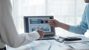 Business people pointing graph and using calculator during business meeting. Business team meeting and presenting business result discussion and analysis data chart and graph finance and accounting. - Powered by Shutterstock - Get 15% off with code: PIKWIZARD15