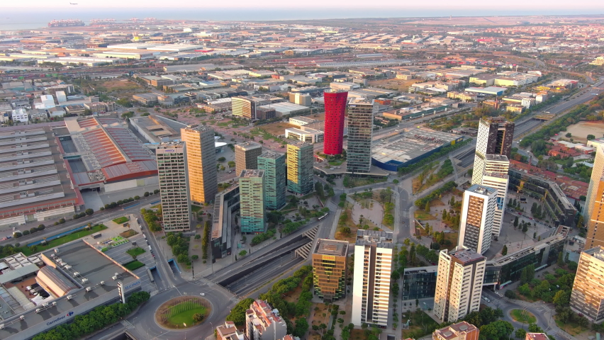 Barcelona city skyline at sunrise. Aerial view of business district of Gran Via and Plaça d'Europa with modern skyscrapers. Europa fira. Catalonia, Spain Royalty-Free Stock Footage #1094616181