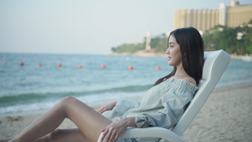 Holiday concept of 4k Resolution. Asian woman resting on the beach happily.