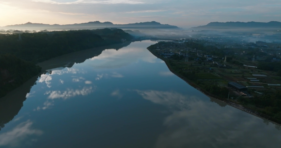 peaceful Aerial landscape of sunrise in the rural river hill clouds reflection in the water at summer morning Sichuan China