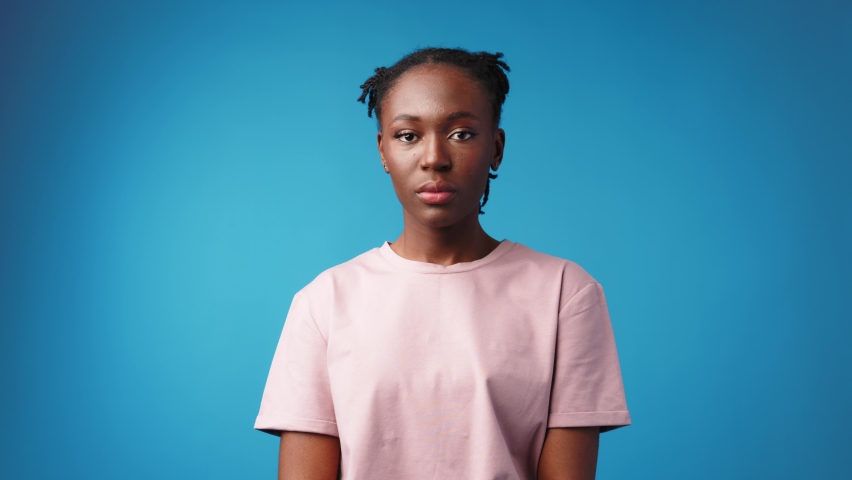 Young casual african woman holding head suffering headache on blue background