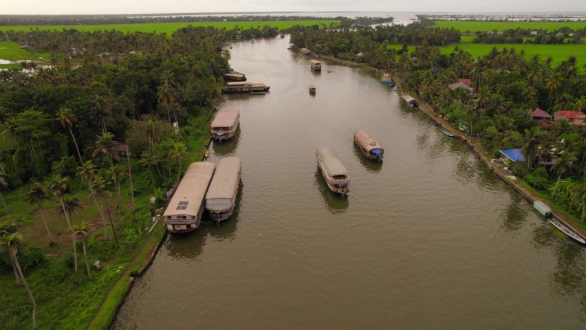 Aerial view of several houseboats sailing in tropical backwaters of Kerala | Shutterstock HD Video #1094631651