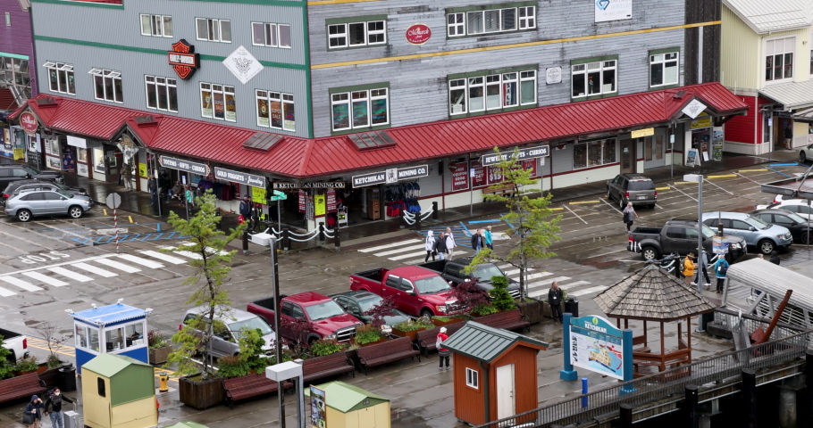 KETCHIKAN, ALASKA - 29 AUG 2022: Ketchikan Alaska shopping tourist area fast motion. Southern most city of Alaska inside passage. Deep water ship port, boat marina. National Historic District.  