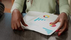 Multiethnic group of coworkers analyzing business charts and diagrams to create company report. People working on research collaboration to plan infographics review and documents. Close up. - Powered by Shutterstock - Get 15% off with code: PIKWIZARD15