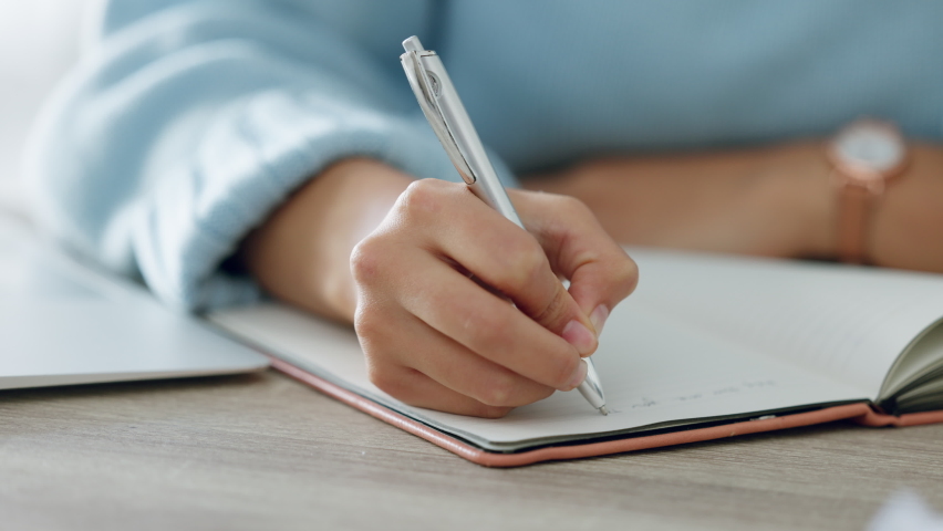 Hands, writing and book of woman with a pen in study journal, diary or notebook at home. Hand of a creative female writer on paper plan, idea or reminder for business goals on table or desk Royalty-Free Stock Footage #1094651033