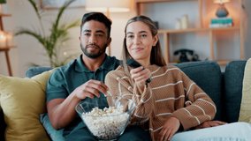 Young couple watching tv, movies and media on subscription streaming service in relax living room with popcorn at home. Smile, relax and happy people connect to cable television show together - Powered by Shutterstock - Get 15% off with code: PIKWIZARD15