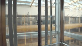 Formal diverse businessmen wear safety mask in glass elevator moving downstairs inside corporate contemporary office building. Realtime - Powered by Shutterstock - Get 15% off with code: PIKWIZARD15