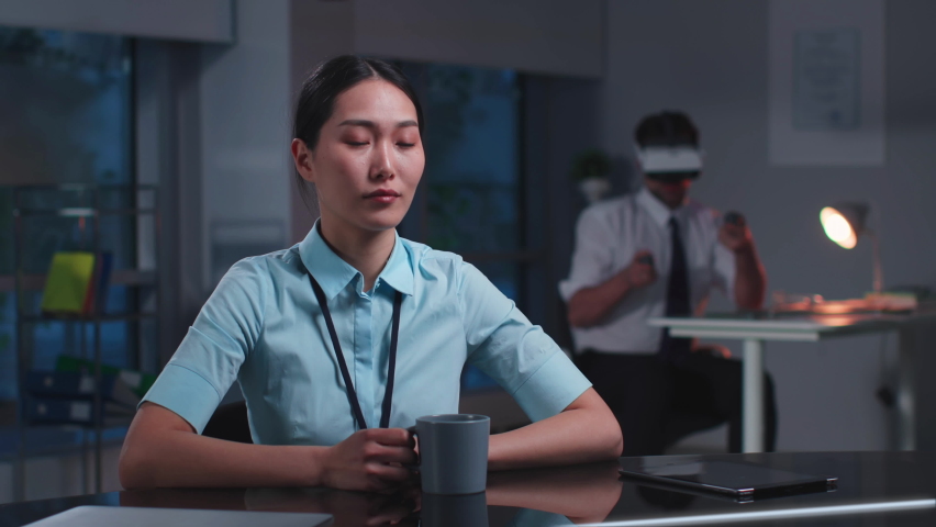 Asian office employee Make Video Call from Computer with Transparent Display. Korean businesswoman have online meeting looking at hologram screen Royalty-Free Stock Footage #1094660101