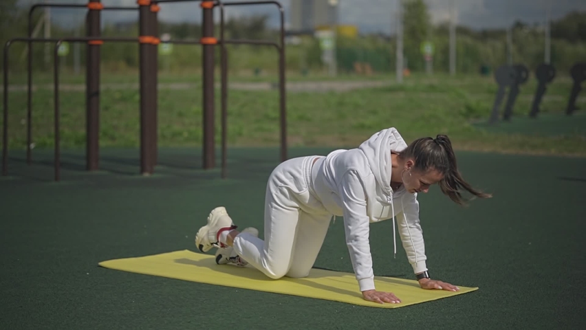 Girl doing exercises in the park | Shutterstock HD Video #1094661909