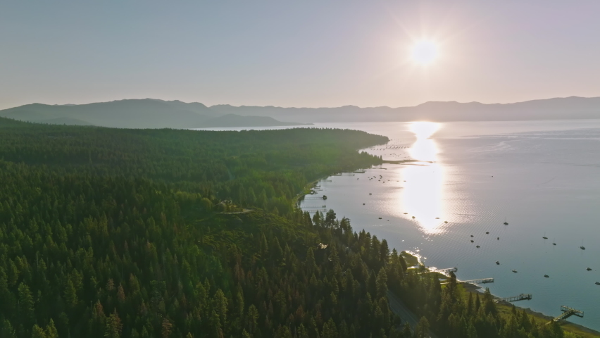 Lake Tahoe Searching Over Clear Blue Turquoise Water And Rocky Shoreline with Pine Tree Forest
