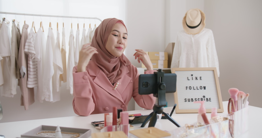 Islam youtuber arab influencer vlogger or beauty blogger live smile talk on social media vlog instagram. Enjoy share selfie viral video sale online on small shop trendy job for asia people Gen Z girl. Royalty-Free Stock Footage #1094666189