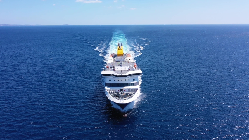 Aerial drone tracking video of Blue Star Paros passenger ferry bow cruising in high speed the Aegean deep blue sea Royalty-Free Stock Footage #1094670473