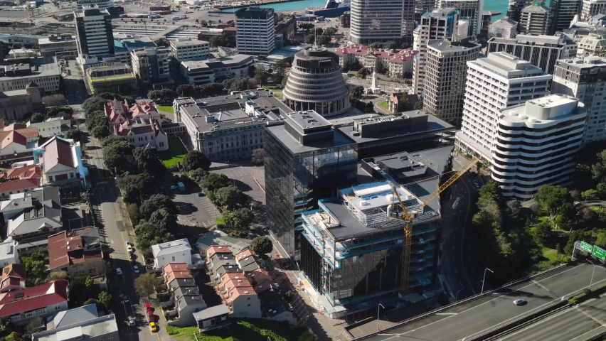 Drone fly to Beehive, New Zealand parliament building in Wellington. Cityscape and harbour