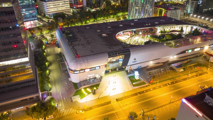 Night drone hyperlapse over contemporary Promenada Mall in Bucharest, Romania