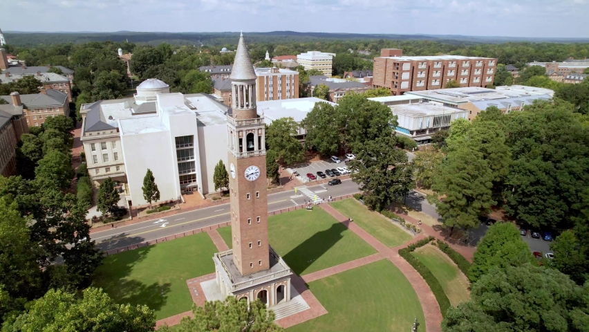 aerial past the moorehead patterson clock tower towards the unc chapel hill campus Royalty-Free Stock Footage #1094673659