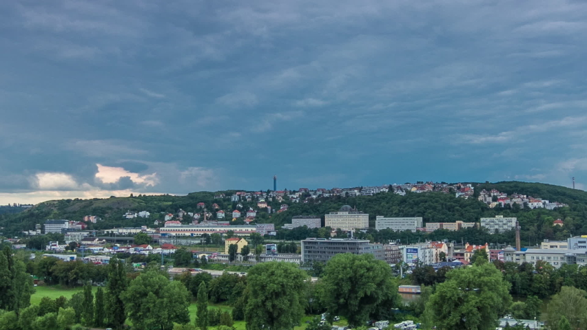 Aerial view of Prague timelapse from the observation deck of Visegrad. Prague. Czech Republic. Vltava river and green trees. Stormy weather with dark clouds