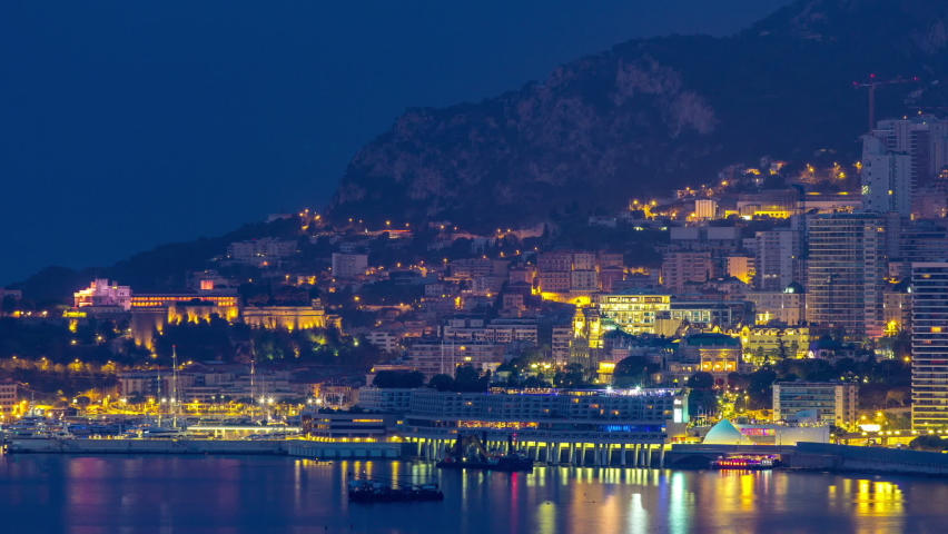 Cityscape of Monte Carlo night to day transition timelapse, Monaco with casino and castle before sunrise. Morning mist. Yachts on harbor. Top view from Cap Martin