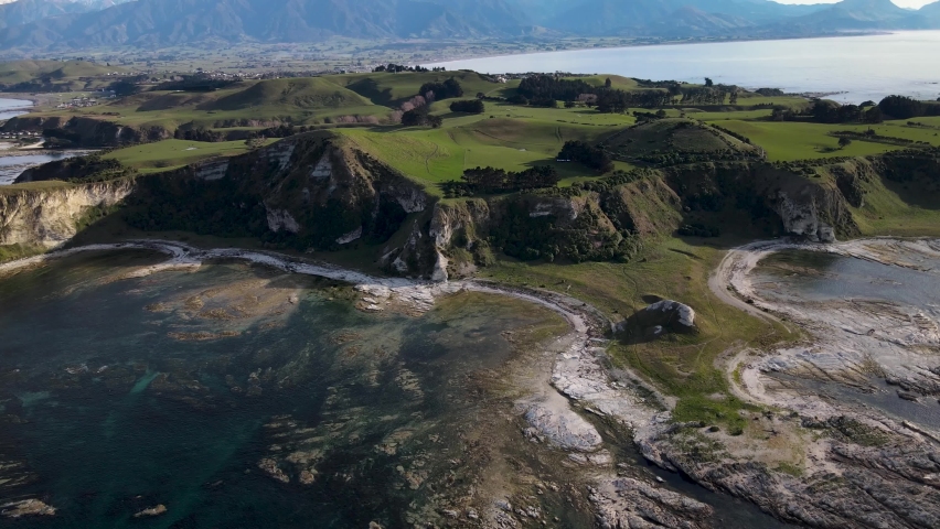 Beautiful aerial scenic landscape of New Zealand. Kaikoura Peninsula on seaside and mountain range.