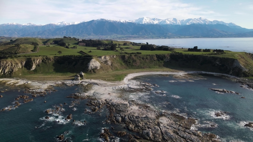 Kaikoura Peninsula and snow capped Southern Alps on New Zealand coastal. Aerial drone pullback