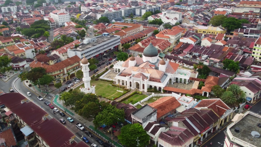 George Town, Malaysia: Aerial drone footage of the historic George Town city center with the Kapitan Keling Mosque in Penang island with chinatown and Little India district with a rotation motion. 