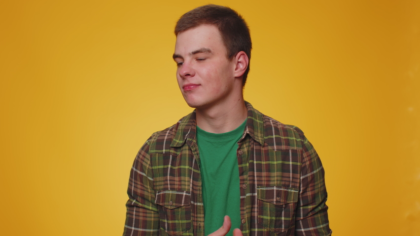 Dissatisfied man shaking head no, asking reason of failure, expressing disbelief irritation, feeling bored, disappointed in result, bad news. Adult boy isolated alone on yellow studio wall background | Shutterstock HD Video #1094687425