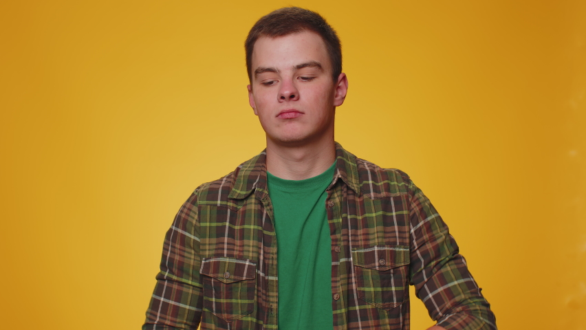 What Why. Sincere irritated adult man raising hands in indignant expression asking reason of failure demonstrating disbelief irritation by troubles. Young confused boy isolated on yellow background | Shutterstock HD Video #1094687437