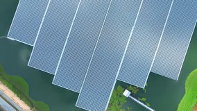 4K : Aerial view of a large floating solar panel during sunrise, clean sustainable energy, renewable electricity. environmental protection concept. drone
