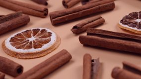 Rotating background with cinnamon sticks and dried lemon or orange slices on a beige background, cozy food, spicy trendy background - Powered by Shutterstock - Get 15% off with code: PIKWIZARD15