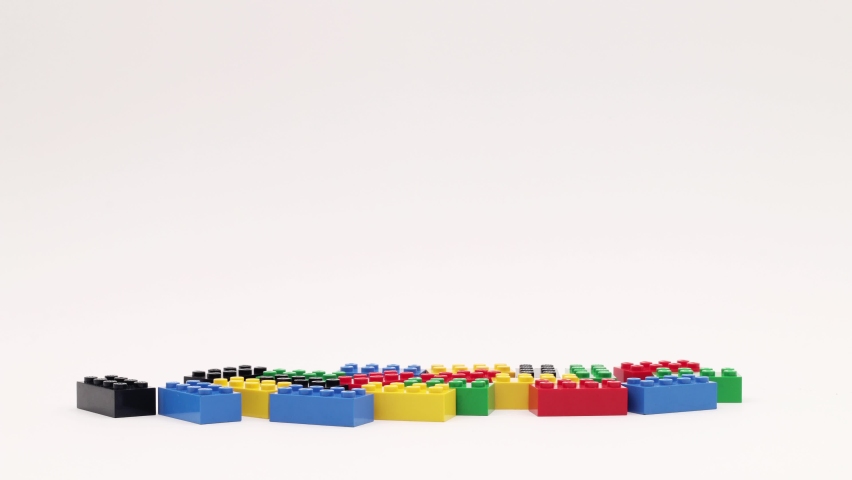 Toy blocks are arranged in colored columns. Stop motion animation. Royalty-Free Stock Footage #1094691591