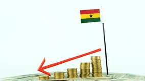 Ghana flag with coins on turntable, inflation concept video, red down arrow, economy and finance idea, Ghana decreasing values, country statistics, 4k 60 fps, economic crisis and downgrade