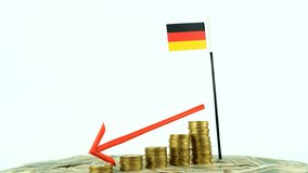 Germany flag with coins on turntable, inflation concept video, red down arrow, economy and finance idea, Germany decreasing values, country statistics, 4k 60 fps, economic crisis and downgrade - Powered by Shutterstock - Get 15% off with code: PIKWIZARD15