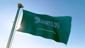 Flag of Saudi Arabia waving in the wind, sky and sun background. Saudi Arabia Flag Video. Realistic Animation.