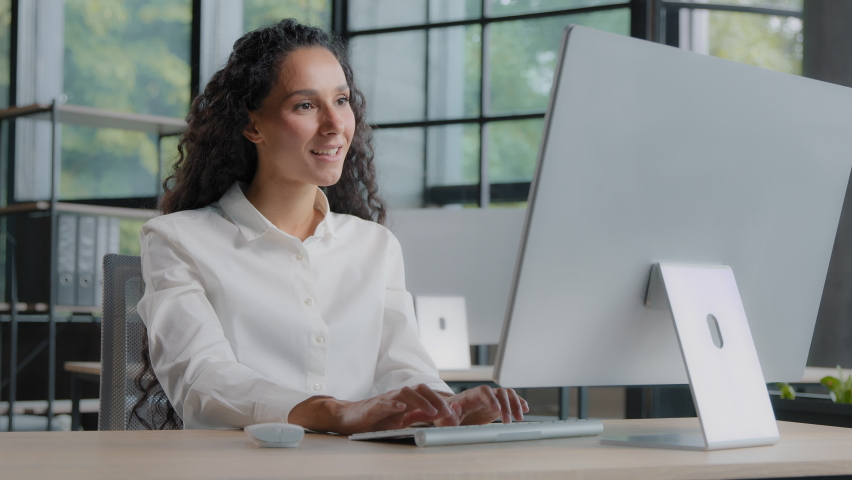 Young confident woman professional manager working on computer typing on keyboard positive businesswoman sits at workplace in search information on internet browsing website in online store make order | Shutterstock HD Video #1094696061