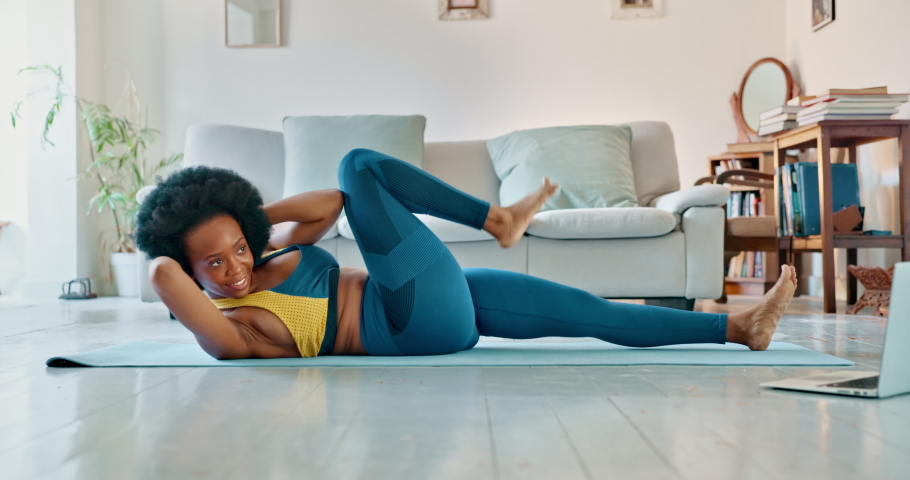 Black woman, home workout and crunch exercise, training and stretching in living room floor. Fitness, wellness and healthy young african female twisting body for situps, strong abs and core | Shutterstock HD Video #1094697841