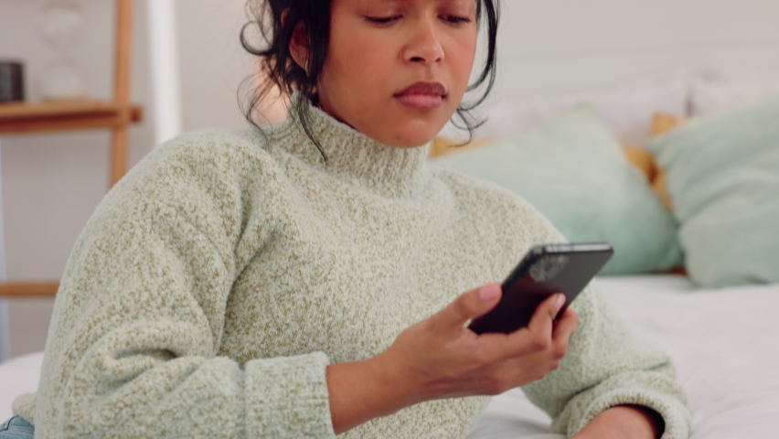 Depression, phone and sad woman on a bed, reading bad news or negative breakup text in bedroom. Thinking, anxiety and depressed female waiting for text, looking lonely and vulnerable alone at home | Shutterstock HD Video #1094697975