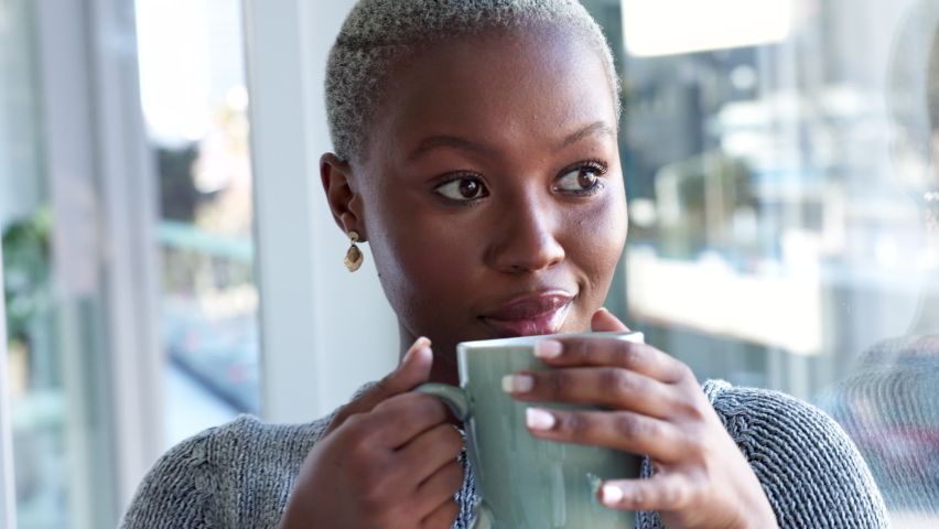 Coffee drink, relax home and black woman thinking of idea, happy in house and smile in the living room of apartment. Face of an African person drinking warm tea and calm in lounge for breakfast | Shutterstock HD Video #1094698029