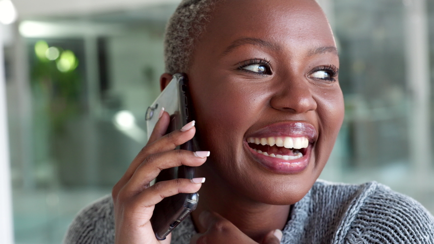 Happy black woman, phone call and office communication for business, vision and motivation in startup. Smile African employee mobile talking, conversation and speaking on smartphone in office | Shutterstock HD Video #1094698041