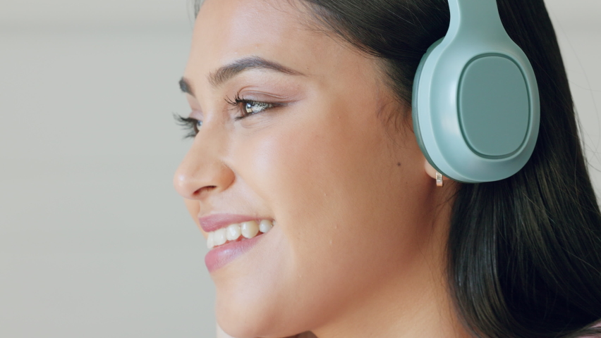 Happy, relax and girl listening to music with headphones streaming radio, podcast or audio books online. Woman with smile and technology for entertainment, peace, calm and relaxing song. | Shutterstock HD Video #1094698161