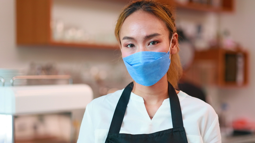 Slow motion VDO. Portrait Asian female owner small business wearing protective face mask at coffee café. | Shutterstock HD Video #1094699577