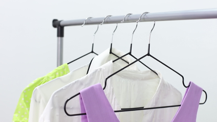 Close-up woman hangs clothes on a hanger. wardrobe | Shutterstock HD Video #1094704265