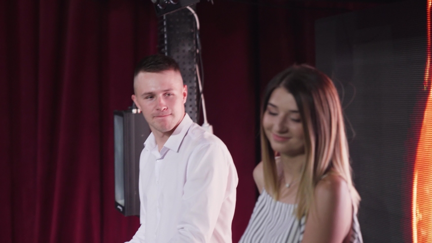 Musicians Duet performans on stage with piano and background interactive board