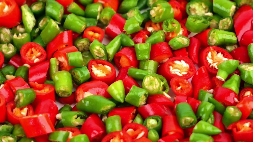 Chili red and green color swirl on a white plate.
