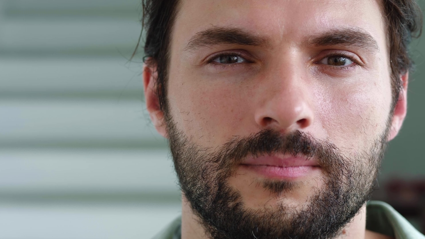Confident face portrait of a focused young bearded Caucasian, 30 year old millennial young man with an insightful and mysterious gaze staring forward at the camera. Male model beauty portrait | Shutterstock HD Video #1094708659