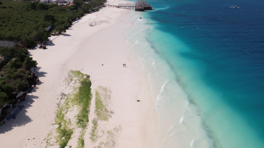 Nungwi Beach in Zanzibar seen from above, white sand and turquoise water, 4K drone movie Royalty-Free Stock Footage #1094712289
