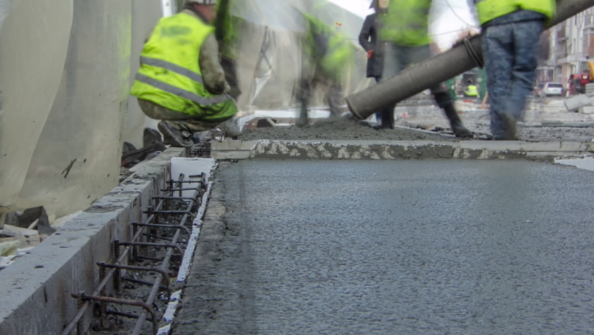 Pouring ready-mixed concrete after placing steel reinforcement to make the road by concrete mixer timelapse hyperlapse. New rails covered by tent. Reconstruction of tram tracks Royalty-Free Stock Footage #1094714739