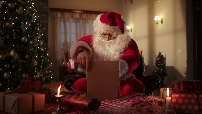 Santa Claus packing Christmas gifts