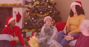 Animation of stars over diverse friends sitting at christmas. Christmas tradition and celebration concept digitally generated video.