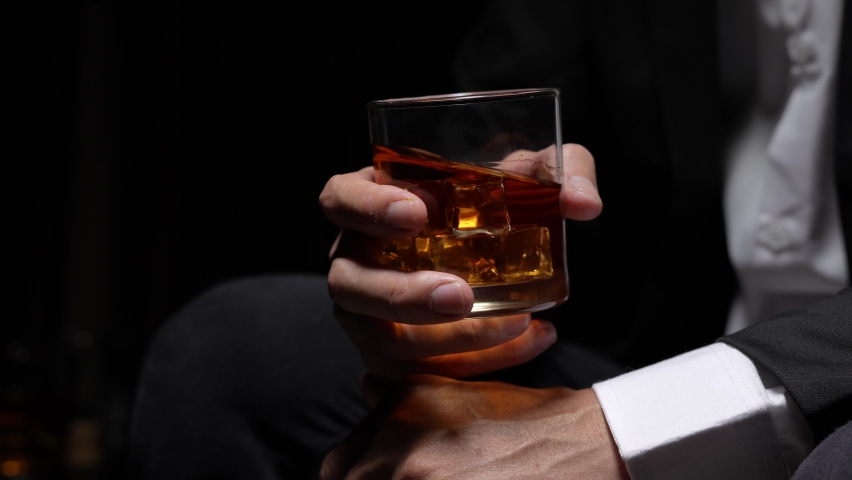businessman holding whiskey, a restaurant