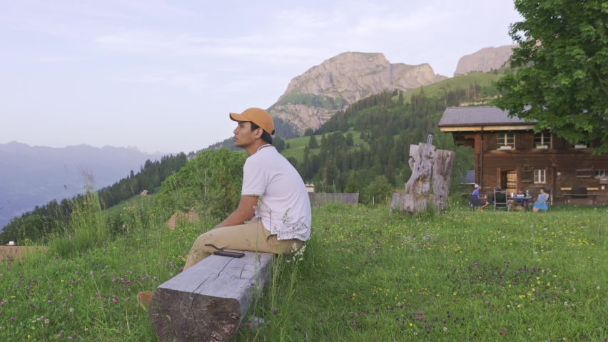 A Man Looking at the Alps Mountain View from The Edge of The Hill, Right Side